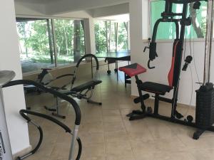 a room with a gym with chairs and a table at Park Hotel Briz - All Inclusive & Free Parking in Golden Sands