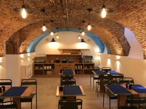 a restaurant with tables and chairs and a kitchen at Apartamentos Apolo in Madrid