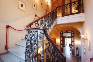 a staircase in a home with a wrought iron railing at Villa Teresa in Porto Azzurro