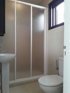 a bathroom with a shower with a toilet and a sink at Sun Luz Apartments 84 in Caleta De Fuste