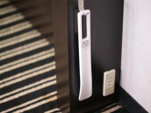 a close up of a door with a white handle at APA Hotel Kyoto Ekikita in Kyoto