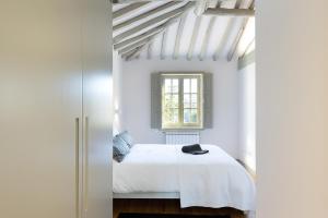 ポルトにあるCasa Amarelaのベッドルーム(白いベッド1台、窓付)