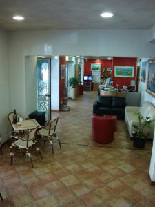 a lobby with a couch and a table and chairs at Hotel Venezia in Caorle