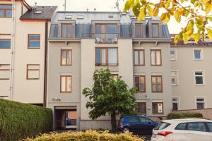 an apartment building with a car parked in front of it at apartmány Marco Shipping in České Budějovice