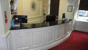 a lobby with a reception desk in a room at Sandyford Hotel in Glasgow