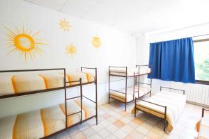 a room with four bunk beds and a window at Ostello Valtrebbia in Marsaglia