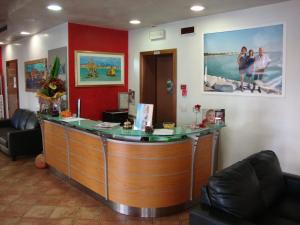 a bar in a waiting room with a counter at Hotel Venezia in Caorle