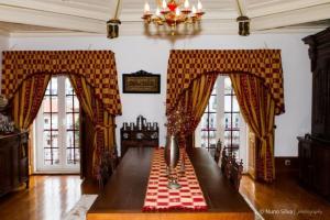 a living room with a table with a red and white checkered table cloth at Casa Do Brasao in Tabuaço