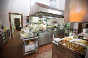 a kitchen with a chef preparing food in a kitchen at La Casa Del Priore in Patti