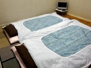 
A bed or beds in a room at Fukuroku
