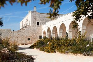 a large brick building with arches on it at Masseria Grieco in Ostuni