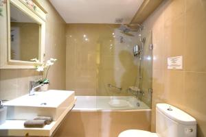a bathroom with a sink and a shower and a toilet at Isabella Country House in Gouvia