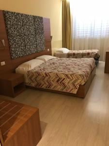 Letto o letti in una camera di Hotel Elys