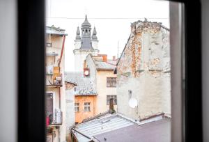 a view of an old building from a window at Art Apartments Rynok Square in Lviv