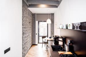a kitchen with a counter and a dining room at Art Apartments Rynok Square in Lviv