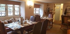 a dining room with a long wooden table and chairs at The Langton Arms in Blandford Forum