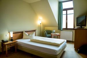 Postel nebo postele na pokoji v ubytování Ringhotel Dreiländereck Zittau + 37 fotografií