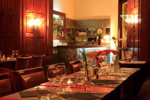 a restaurant with a long table with wine glasses at Le Windsor, Jungle Art Hotel in Nice