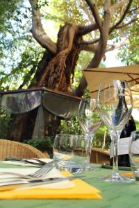 a table with two wine glasses on top of it at Le Windsor, Jungle Art Hotel in Nice