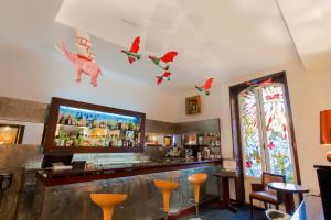 a bar with christmas decorations on the ceiling at Le Windsor, Jungle Art Hotel in Nice