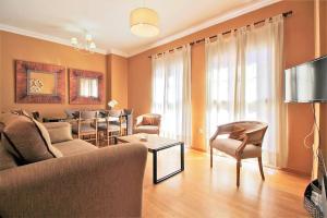 salon z kanapą i stołem w obiekcie Del Parque Flats - Cervantes w Maladze