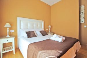 Łóżko lub łóżka w pokoju w obiekcie Del Parque Flats - Cervantes
