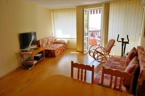 a living room with a couch and a table at GT Privilege Fort Beach Apartments in Elenite