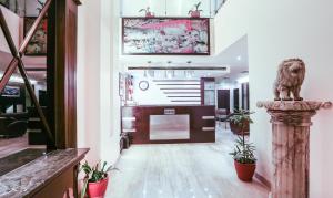 a lobby with potted plants in a building at Hotel Fairway in Amritsar