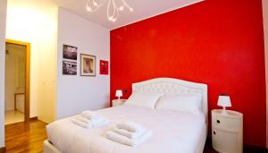 ミラノにあるItalianway-Rucellaiの赤い壁のベッドルーム1室(白いベッド1台付)