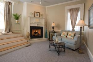 a living room with a couch and a fireplace at Captain Farris House in South Yarmouth