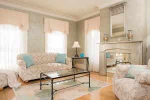 a living room with two couches and a fireplace at Captain Farris House in South Yarmouth