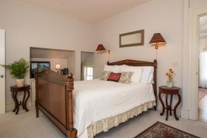 a bedroom with a large bed and two tables at Captain Farris House in South Yarmouth