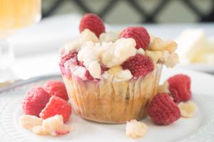 a muffin with raspberries and popcorn on a plate at Captain Farris House in South Yarmouth