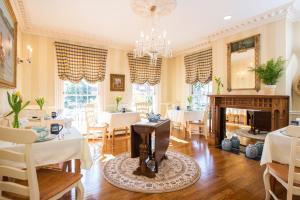 a dining room with a table and a fireplace at Captain Farris House in South Yarmouth