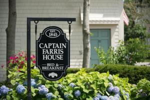 a sign in a garden in front of a house at Captain Farris House in South Yarmouth