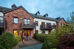 a large brick house with two balconies on it at The Whitbarrow Hotel at Whitbarrow Village in Troutbeck