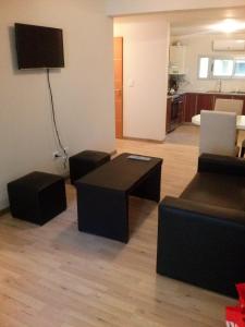 a living room with a couch and a table at Bahiaxdia Fitz Roy 140 in Bahía Blanca