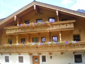 a building with flower boxes on the balcony at Veitenhof in Krimml