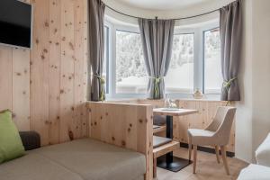a hotel room with a table and a window at Hotel Garni Pirchhütt in Obergurgl