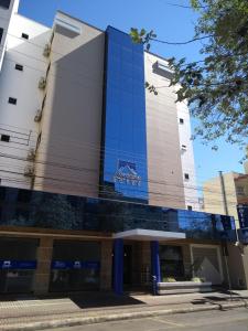 a building with a sign on the side of it at Asppen Hotel in Chapecó