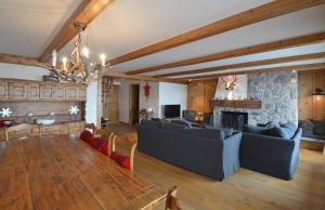 a living room with couches and a stone fireplace at Combe de l'A 222 in Verbier