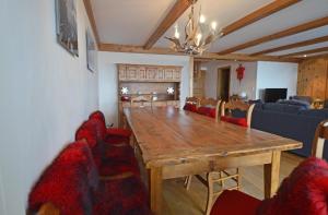 a dining room with a wooden table and chairs at Combe de l'A 222 in Verbier