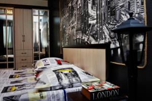 a bedroom with a bed with a newspaper on it at ATLANT Apartments 171 in Voronezh
