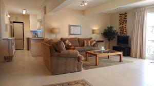 a living room with a couch and a coffee table at Agape Apartments in Somerset West