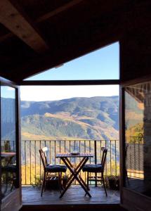 a table and chairs on a balcony with a view at Casa Camp in Enviny