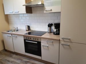 a kitchen with a sink and a stove top oven at Emderhaus in Emden