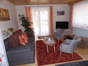 a living room with a couch and chairs and a tv at Ferienwohnung Janko in Meßstetten