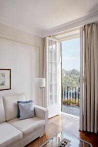 a living room with a couch and a large window at Splendido, A Belmond Hotel, Portofino in Portofino