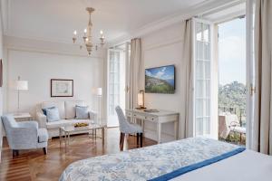 a bedroom with a bed and a desk and a couch at Splendido, A Belmond Hotel, Portofino in Portofino