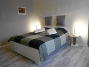a bedroom with a large bed with two pillows at Litdevin in Uchizy